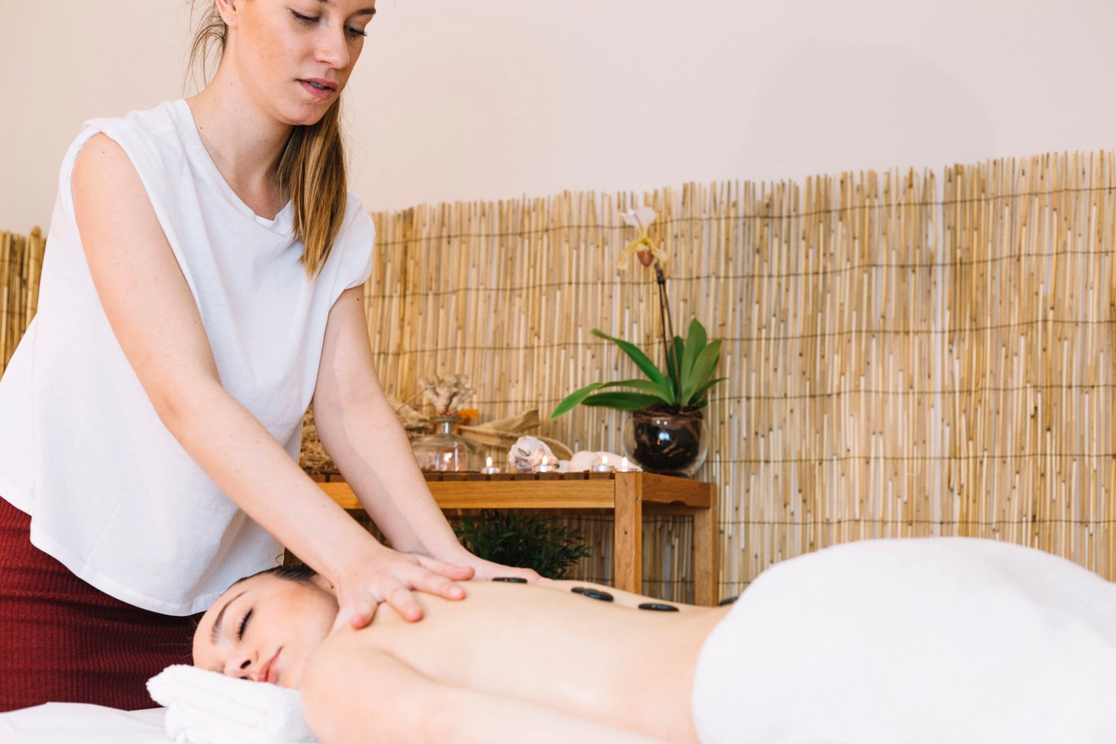 massage-concept-with-stones-womans-back